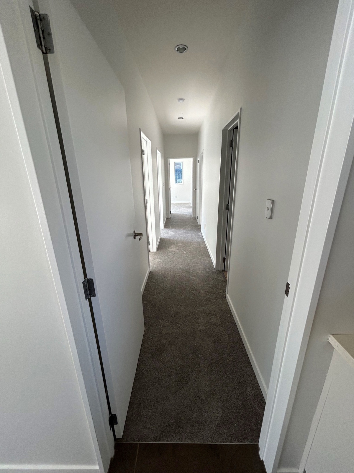 New carpet fitted through a clean hallway