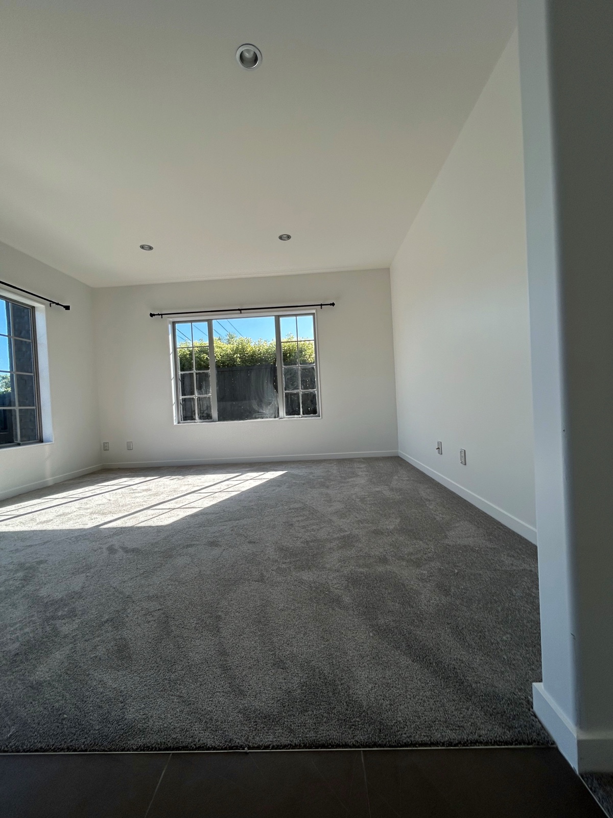Sunlit room with newly installed grey carpet